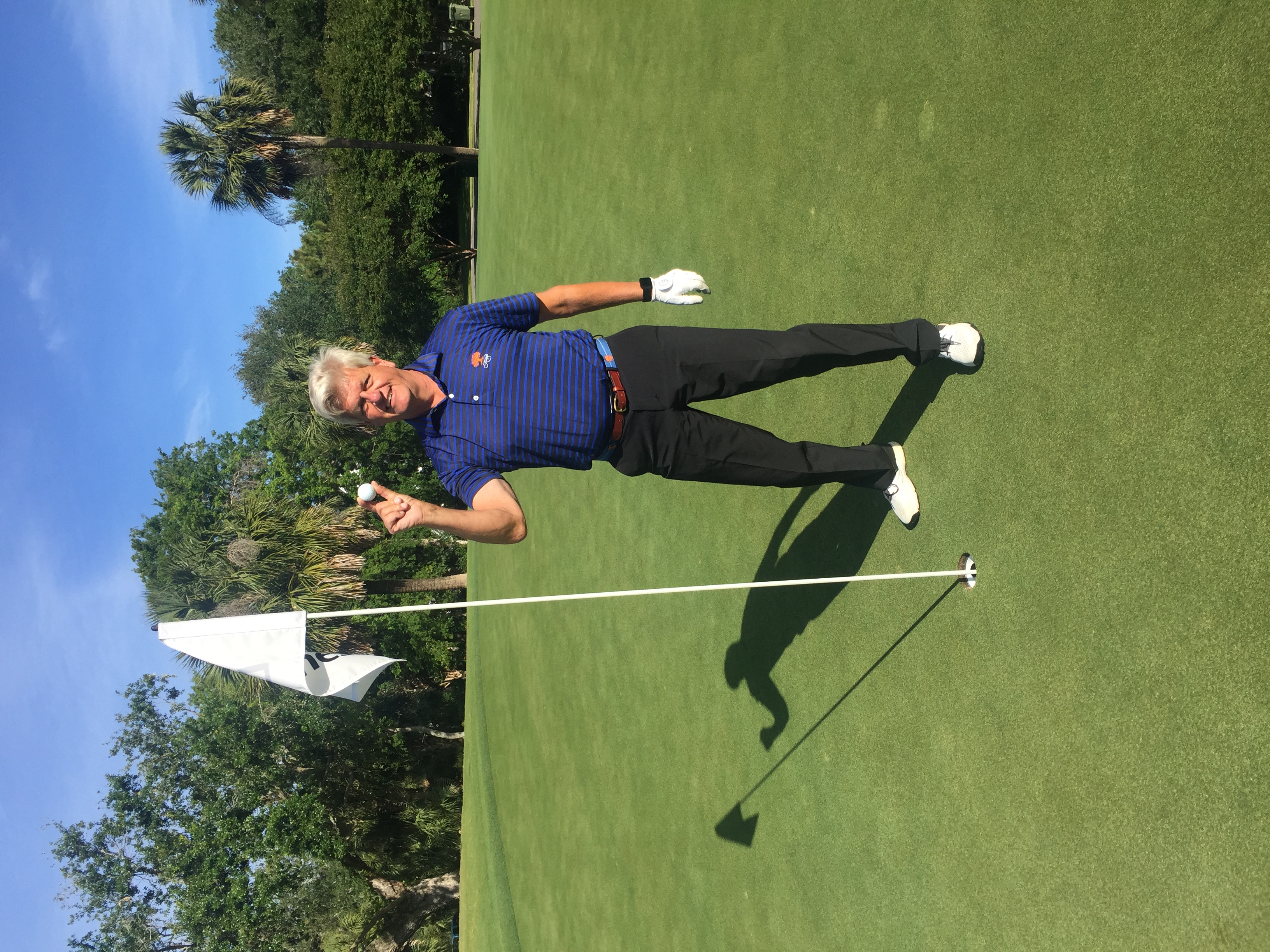 Member celebrating a hole in one on the green at Wild Dunes