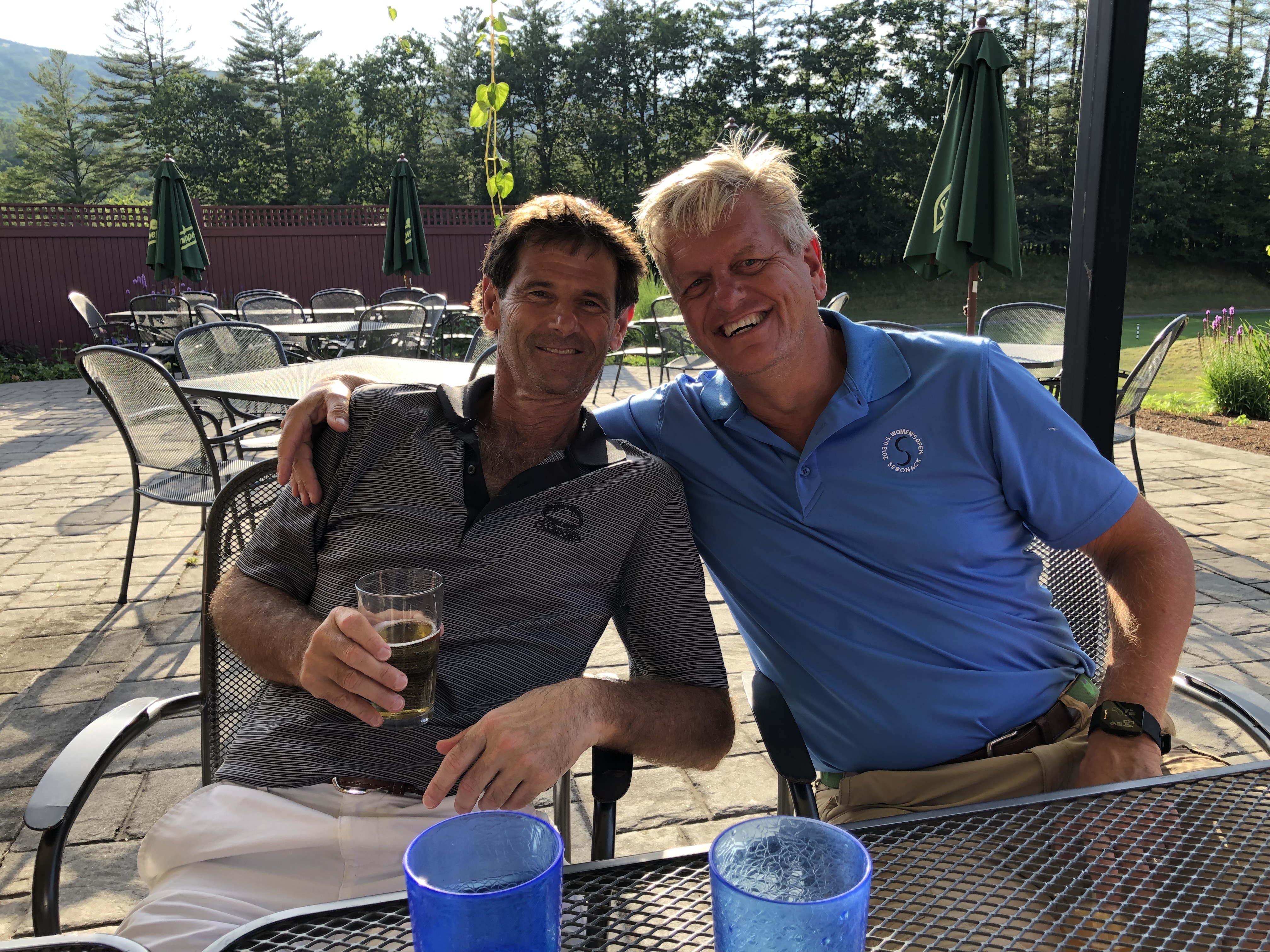 Two Wild Dunes members relaxing on the patio after a round of golf